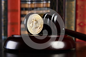 Crypto currency law, judge gavel, stacked legal book and bitcoin