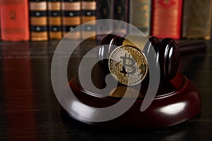 Crypto currency law, judge gavel, stacked legal book and bitcoin