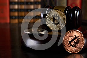 Crypto currency law, judge gavel, stacked legal book and bitcoin