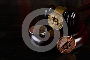 Crypto currency law, judge gavel, stacked legal book and bitcoin