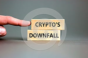 Crypto downfall symbol. Concept words Cryptos downfall on wooden blocks. Beautiful grey table grey background. Businessman hand.
