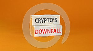 Crypto downfall symbol. Concept words Cryptos downfall on wooden blocks. Beautiful orange table orange background. Business and