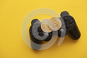 Crypto gaming concept. Video game controller with a bitcoin cryptocurrency coin