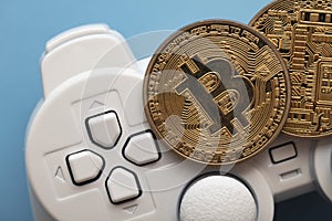 Crypto gaming concept. Video game controller with a bitcoin cryptocurrency coin