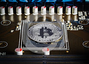 Cryptocurrency bitcoin silver coins on circuit board