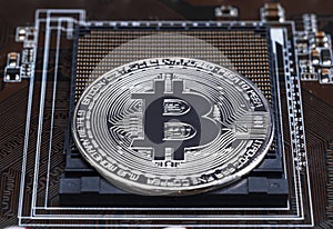 Cryptocurrency bitcoin silver coins on circuit board