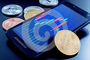 Stacked cryptocurrency coins and cell phone