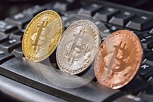 Cryptocurrency coins over black keyboard; Bitcoin coins