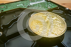 Cryptocurrency Golden Bitcoin on hard disk drive