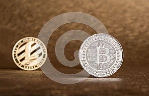 Cryptocurrency Lite coin,Silver Bitcoin on golden rough background,Digital cryto currencies.Virtual digital money. photo