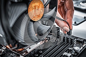 Cryptocurrency mining. Bitcoin coin on a graphic card, video card for cryptocurrency mining. Cryptocurrency.