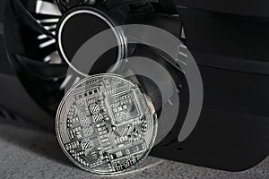 Cryptocurrency mining. Cryptocurrency mining. Bitcoin coin on a graphic card, video card for cryptocurrency mining.