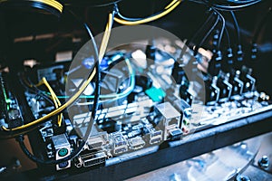 Cryptocurrency mining rig PCIe riser extenders plugged to motherboard.