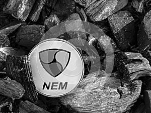 Cryptocurrency Nem coin lies on coal. Mining and Energy for mining.