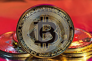 Cryptocurrency physical golden bitcoin coin on colorful background