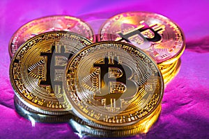 Cryptocurrency physical golden bitcoin coin on colorful background