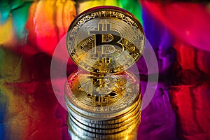 Cryptocurrency physical golden bitcoin coin on colorful background