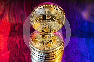 Cryptocurrency physical golden bitcoin coin on colorful background