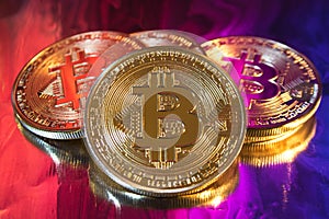 Cryptocurrency physical golden bitcoin coin on colorful background