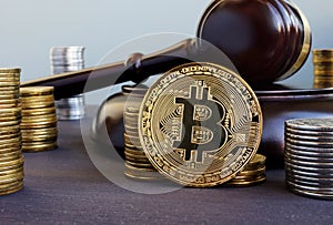 Cryptocurrency regulation. Bitcoin and gavel on a desk.