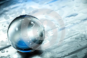 Crystal ball in abstract blue with reflections.