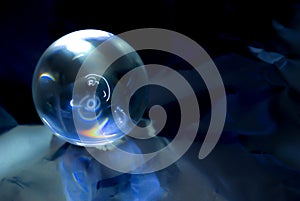 Crystal ball in blue abstract light.