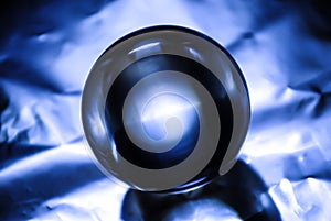 Crystal ball in blue abstract light.