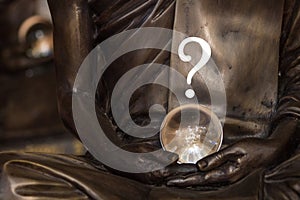 Crystal ball in the hands of a monk surmounted by a question mark, predicting the future