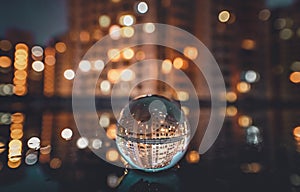 Crystal ball reflecting night cityscape