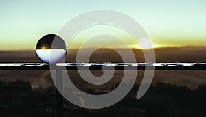 Crystal ball with a reflection of the sunset in it