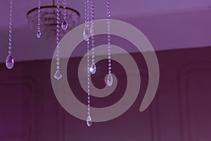 Crystal beads, purple light, hanging ceiling.