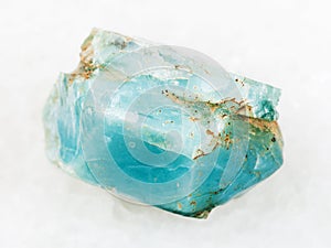 crystal of blue apatite gemstone on white