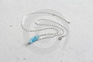 Crystal blue aquamarine beryl on a silver chain. Pendant aquamarine, pendant, decoration on the neck. Natural blue aquamarine on a