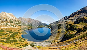 Crystal blue mountain lake in High Tatra Mountains, Five Polish Ponds Valley Dolina Pieciu Stawow Polskich in autumn, Poland