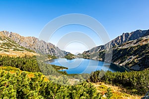 Crystal blue mountain lake Wielki Staw in High Tatra Mountains, Five Polish Ponds Valley, Poland