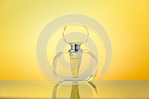 Crystal bottle on yellow gradient background