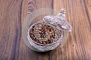 Crystal bowl full of natural coffee beans. International Coffee Day concept. October 1st