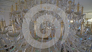 Crystal chandelier. Close up of the crystals. Low angle shot of a big beautiful crystal luxury chandelier. With bling