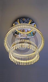 Crystal Chandelier hanging under a ceiling with reflection