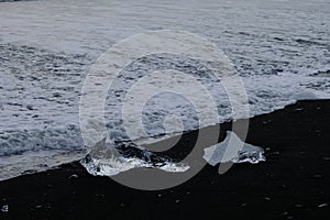 Crystal Clear and Blue Ice Floes on a Black Sand Beach on the Iceland Coast