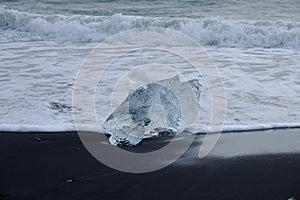 Crystal Clear and Blue Ice Floes on a Black Sand Beach on the Iceland Coast