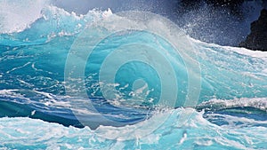 Crystal clear blue wave close-up photo