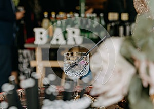 Crystal-clear gin and tonic sitting on table in a modern wedding venue