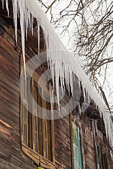 Crystal clear icicles hang on the edge of the roof.