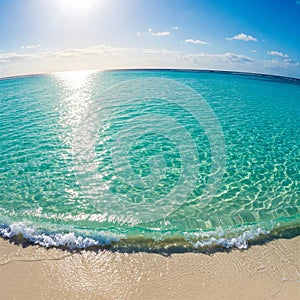 Turquoise Ocean Waves Sparkling Under the Midday Sun on a Tropical Beach photo