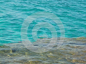 Crystal clear turquoise water on rocky bottom