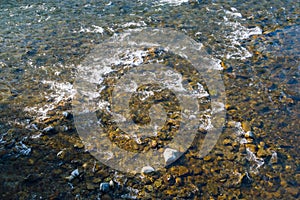 Crystal clear water over creek bed and colourful pebbles