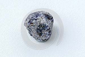 Crystal of cordierite iolite gem stone cutout, raw mineral, white background