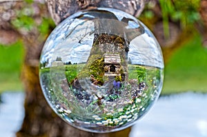 Crystal Glass Ball Sphere reveals Fairy House in front of Apple Tree