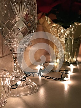 A crystal glass sits in front of holiday and Christmas decorations